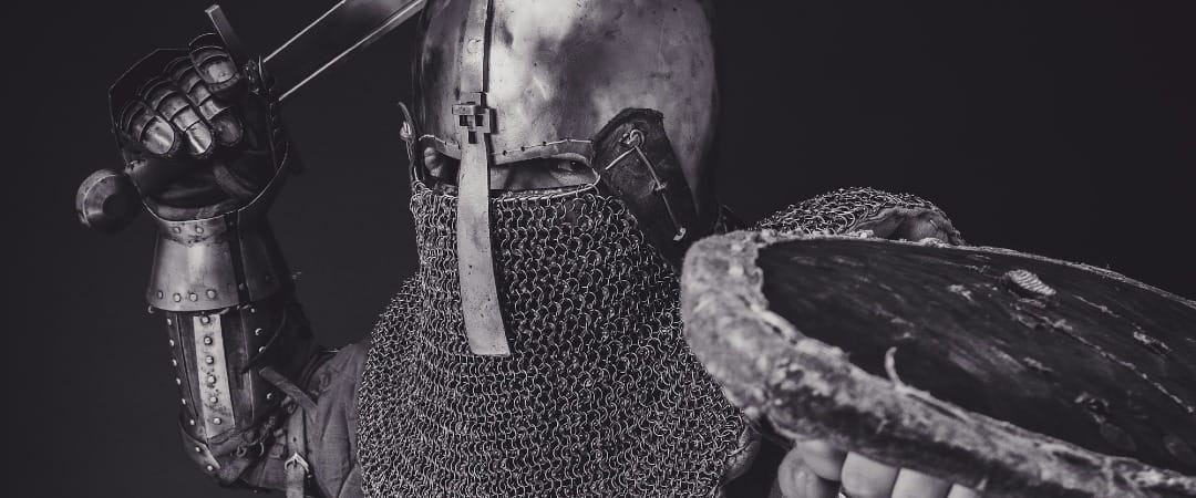 man with steel and chainmail armor holding sword